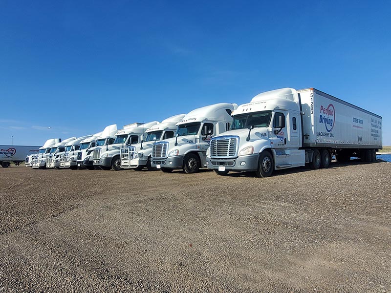 Many of Branded People Driving Academy's trucks on the parking lot